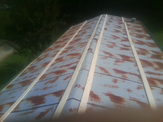 Rusted metal roof panels with new wood purlins before replacement — Storm Damage Roof Repair in Wood Ridge by Roofing Brothers