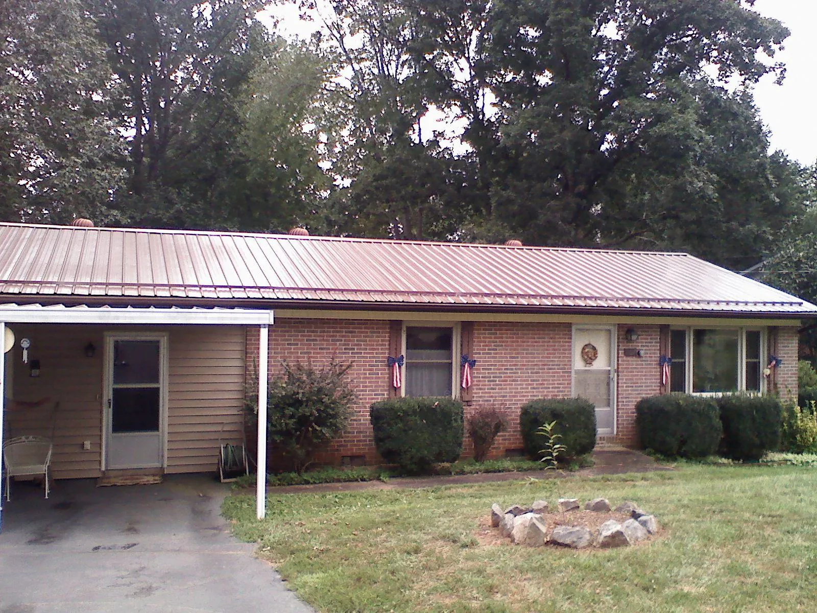 Bronze metal roof and carport on a brick ranch home — Roof Repair work by our crew in Wood Ridge