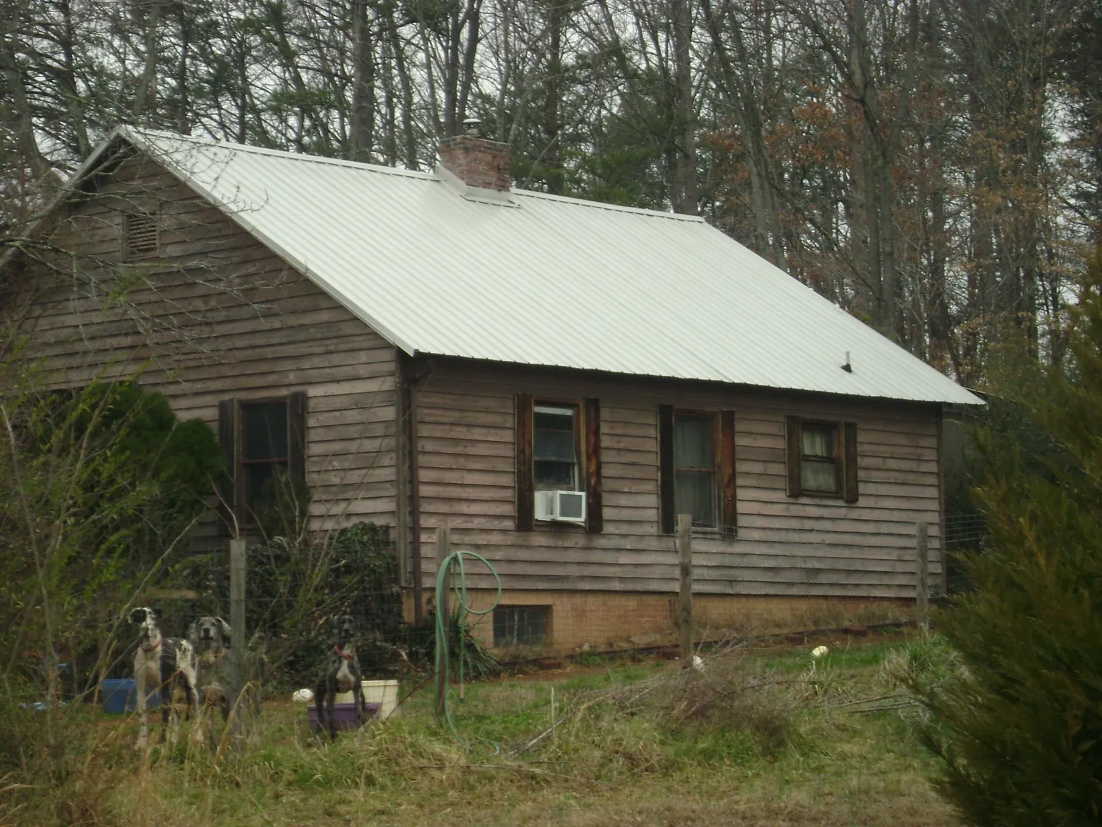 White metal roof on an old wood sided farmhouse in Wood Ridge